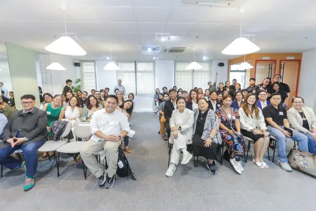 A full room of DashCon 2025 attendees smiling at The Company Manila