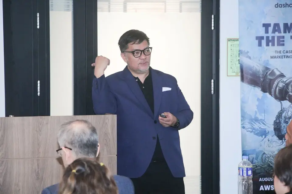 Dominic Ligot speaking at the front of the room at DashCon 2024